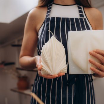 the girl holds a self-made candle in her hands. close-up